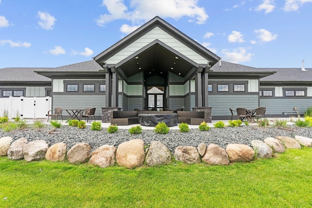 7237 Ada Dr, Lino Lakes, MN 55038 - rear view of house featuring board and batten siding, a shingled roof, a gate, and a patio area