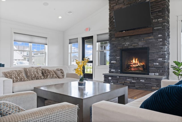 7237 Ada Dr, Lino Lakes, MN 55038 - living room with vaulted ceiling, wood finished floors, a stone fireplace, and healthy amount of natural light