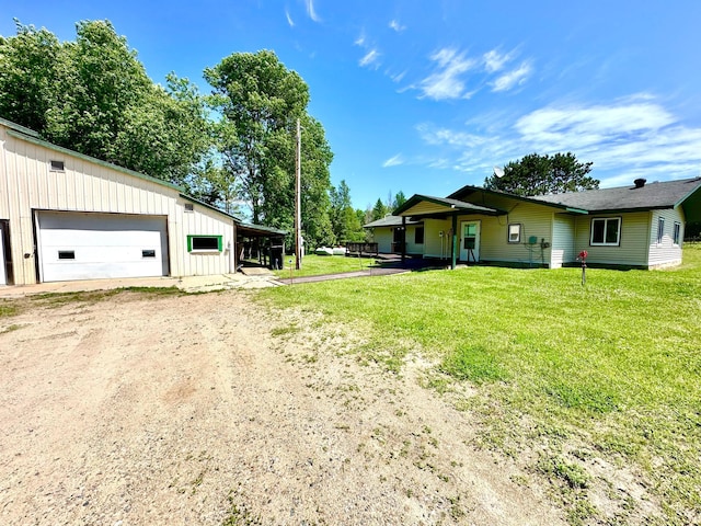 16033 Popplewood Rd NE, Hines Twp, MN 56647 - view of green lawn featuring dirt driveway and a garage