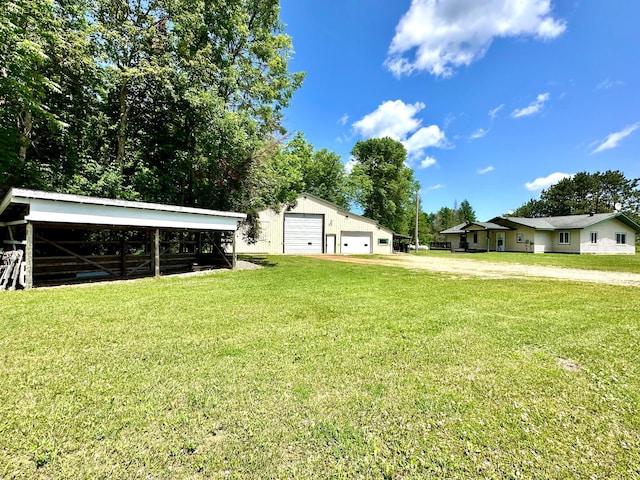 16033 Popplewood Rd NE, Hines Twp, MN 56647 - view of grassy yard featuring a detached garage, an outbuilding, a pole building, and driveway