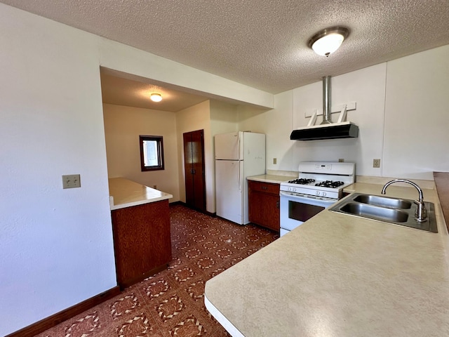 16033 Popplewood Rd NE, Hines Twp, MN 56647 - kitchen with white appliances, range hood, a textured ceiling, light countertops, and dark floors