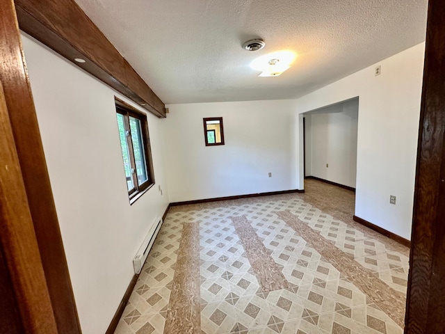 16033 Popplewood Rd NE, Hines Twp, MN 56647 - empty room with a baseboard heating unit, a textured ceiling, and light carpet