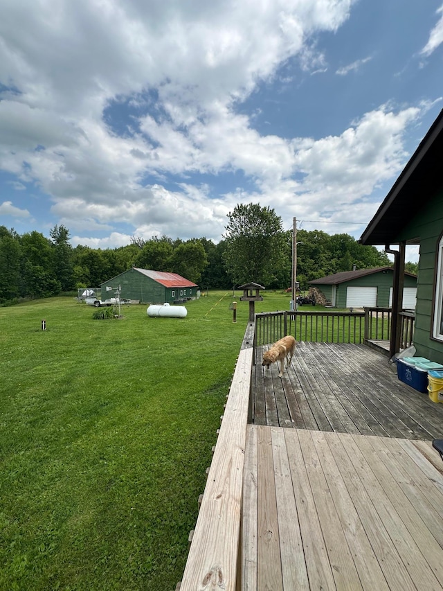 1374 State Highway 11 SE, Baudette, MN 56623 - wooden terrace with a lawn and a garage