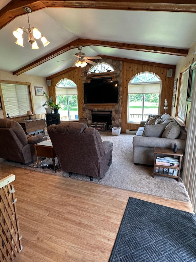 1374 State Highway 11 SE, Baudette, MN 56623 - living area with wood finished floors, a chandelier, a stone fireplace, ceiling fan, and baseboard heating
