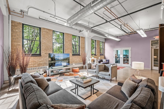 730 Stinson Blvd Unit 504, Minneapolis, MN 55413 - living area with brick wall, plenty of natural light, french doors, and a towering ceiling