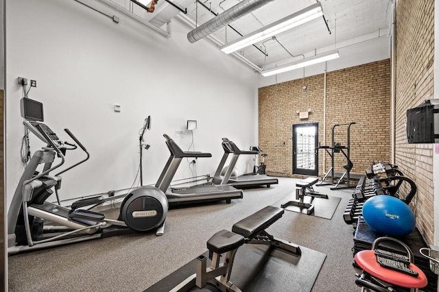 730 Stinson Blvd Unit 504, Minneapolis, MN 55413 - exercise room with brick wall and a towering ceiling
