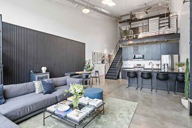 730 Stinson Blvd Unit 504, Minneapolis, MN 55413 - living room with a high ceiling, concrete flooring, and stairs