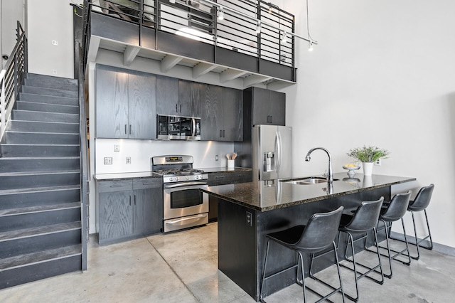 730 Stinson Blvd Unit 504, Minneapolis, MN 55413 - kitchen with stainless steel appliances, concrete floors, a breakfast bar, and dark stone countertops