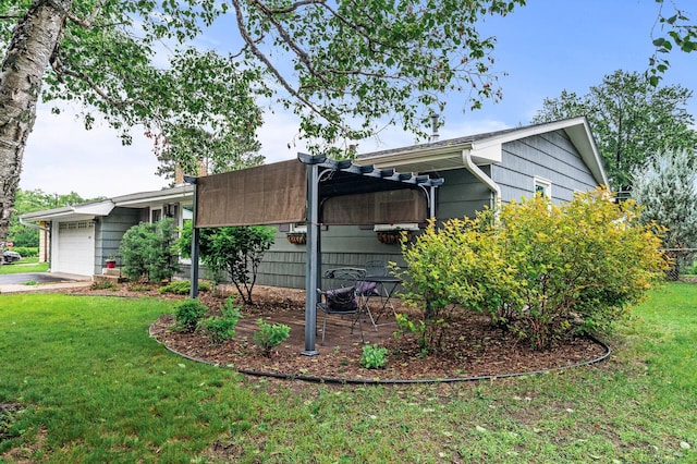 6781 Plaza Curv NE, Fridley, MN 55432 - view of side of home with a yard, an attached garage, and driveway