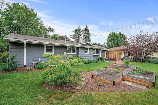 6781 Plaza Curv NE, Fridley, MN 55432 - rear view of property featuring a vegetable garden and roof with shingles