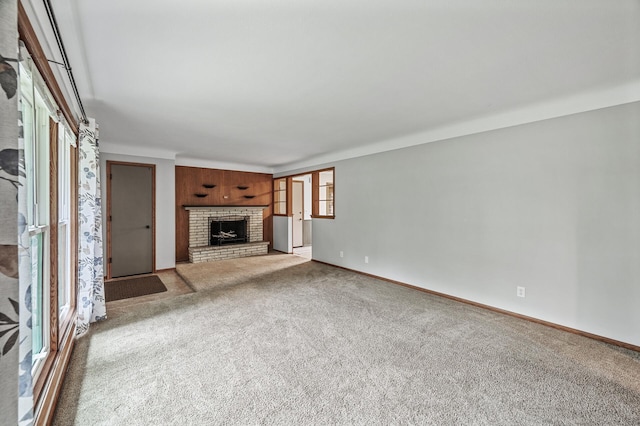 6781 Plaza Curv NE, Fridley, MN 55432 - unfurnished living room featuring carpet floors and a brick fireplace