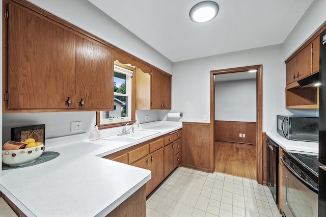 6781 Plaza Curv NE, Fridley, MN 55432 - kitchen with stainless steel electric range oven, black microwave, wainscoting, light countertops, and a peninsula