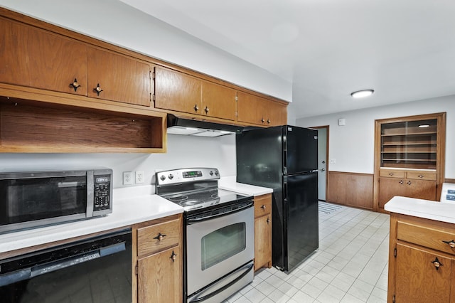 6781 Plaza Curv NE, Fridley, MN 55432 - kitchen featuring black appliances, under cabinet range hood, light countertops, wainscoting, and brown cabinets