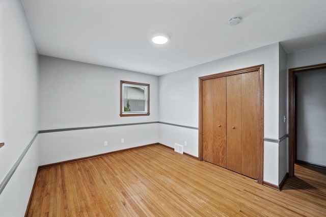 6781 Plaza Curv NE, Fridley, MN 55432 - unfurnished bedroom featuring light wood-style floors and a closet