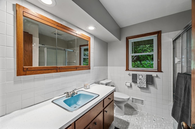6781 Plaza Curv NE, Fridley, MN 55432 - full bathroom featuring vanity, tile patterned floors, a shower stall, tile walls, and recessed lighting