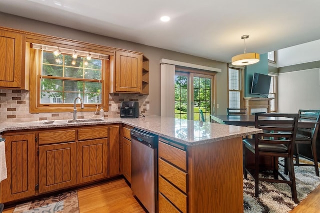 16503 Biscayne Blvd, Eden Prairie, MN 55347 - kitchen with dishwasher, a peninsula, light wood-type flooring, brown cabinets, and tasteful backsplash