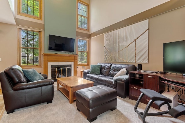 16503 Biscayne Blvd, Eden Prairie, MN 55347 - living area with a towering ceiling, plenty of natural light, light carpet, and a tiled fireplace