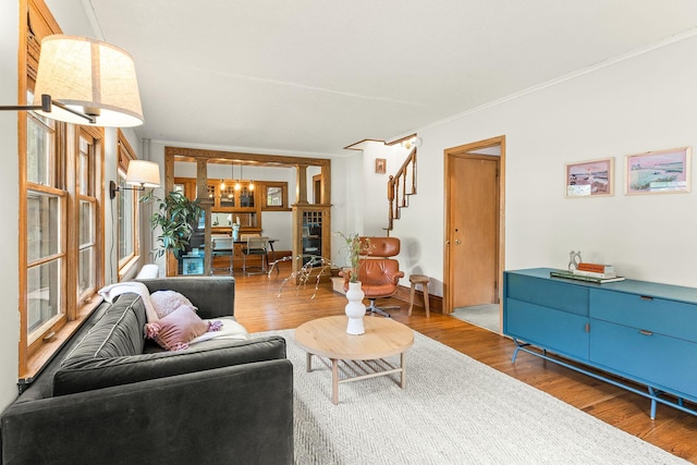 784 Fairview Ave N, Saint Paul, MN 55104 - living room featuring a chandelier, wood finished floors, stairway, and ornamental molding