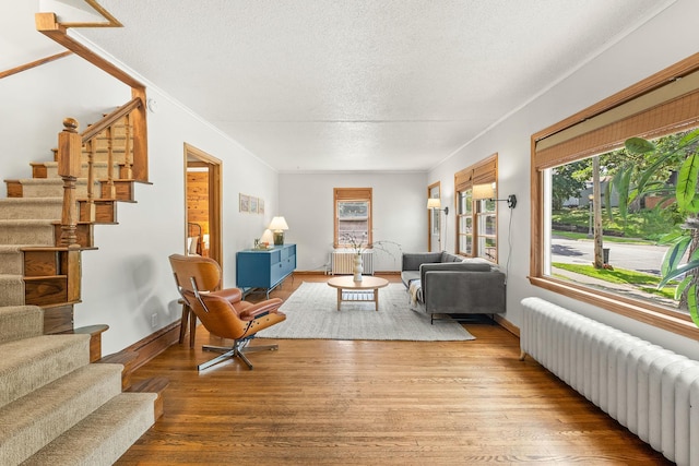 784 Fairview Ave N, Saint Paul, MN 55104 - living room with radiator, stairway, a textured ceiling, and wood finished floors
