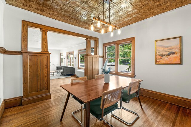 784 Fairview Ave N, Saint Paul, MN 55104 - dining space with an ornate ceiling, hardwood / wood-style flooring, decorative columns, and a chandelier