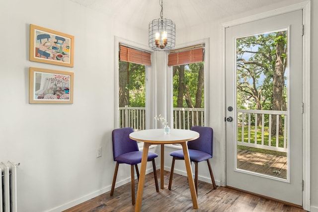 784 Fairview Ave N, Saint Paul, MN 55104 - dining room with radiator heating unit, a chandelier, and wood finished floors