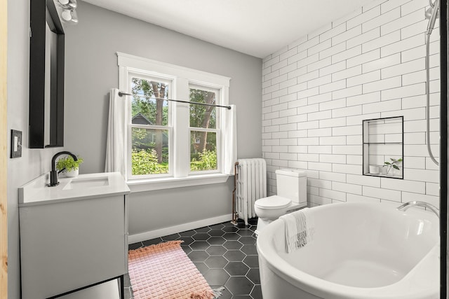 784 Fairview Ave N, Saint Paul, MN 55104 - full bath featuring radiator heating unit, a freestanding bath, vanity, tile patterned flooring, and tile walls