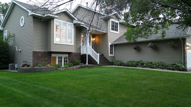 2174 Ponds Way, Shakopee, MN 55379 - view of front of home featuring a front lawn, a garage, brick siding, and roof with shingles