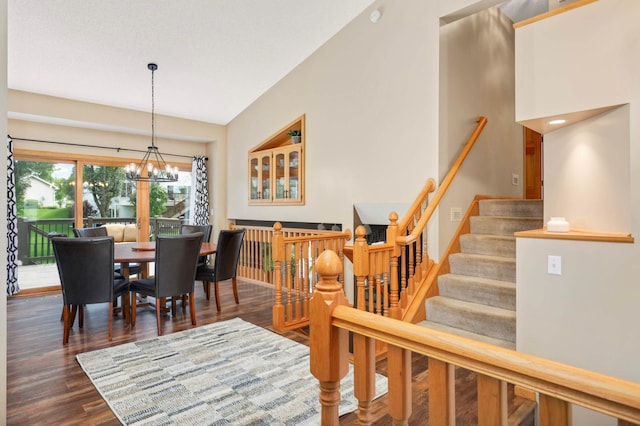 2174 Ponds Way, Shakopee, MN 55379 - dining space featuring dark wood-style flooring, a chandelier, and stairway