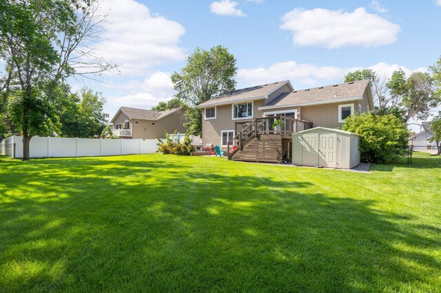 2174 Ponds Way, Shakopee, MN 55379 - back of property featuring a storage shed, a wooden deck, a fenced backyard, and stairway