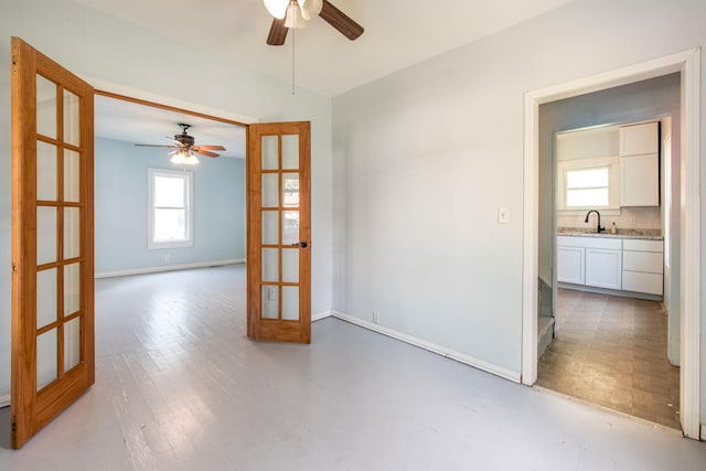 610 2nd St SW, Wadena, MN 56482 - unfurnished room featuring french doors, ceiling fan, plenty of natural light, and light flooring