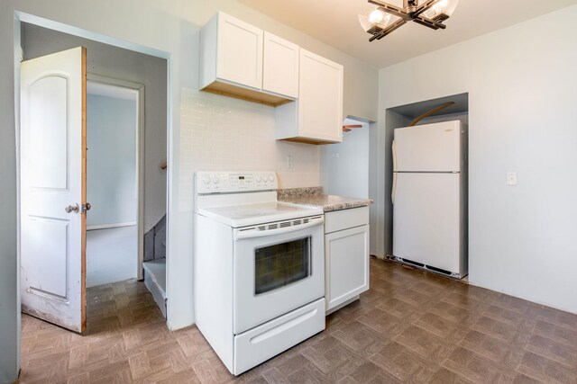 610 2nd St SW, Wadena, MN 56482 - kitchen featuring white appliances, light countertops, white cabinetry, tasteful backsplash, and light floors
