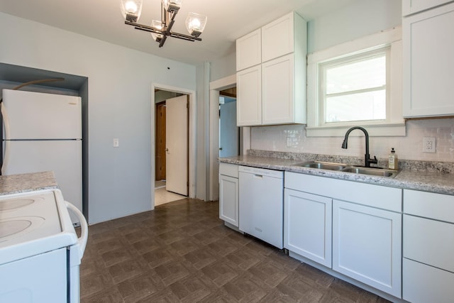 610 2nd St SW, Wadena, MN 56482 - kitchen with white appliances, a chandelier, tasteful backsplash, light countertops, and white cabinets