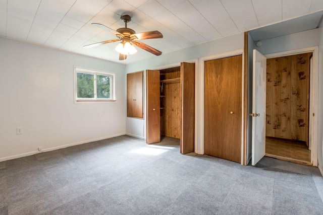 610 2nd St SW, Wadena, MN 56482 - unfurnished bedroom with carpet floors, multiple closets, and a ceiling fan