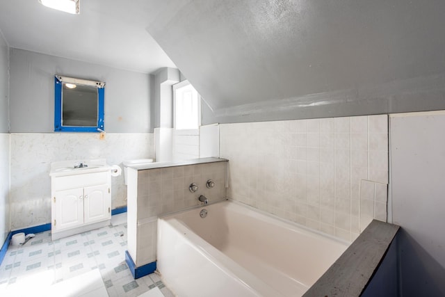 610 2nd St SW, Wadena, MN 56482 - bathroom with a garden tub, vanity, tile patterned floors, and tile walls