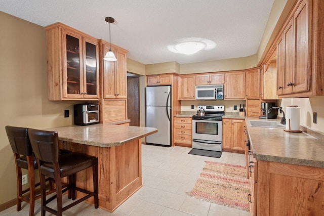 1648 Comstock Ln N, Plymouth, MN 55447 - kitchen with range with electric stovetop, freestanding refrigerator, a peninsula, a textured ceiling, and glass insert cabinets