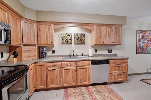 1648 Comstock Ln N, Plymouth, MN 55447 - kitchen with appliances with stainless steel finishes, light tile patterned floors, a textured ceiling, and light countertops