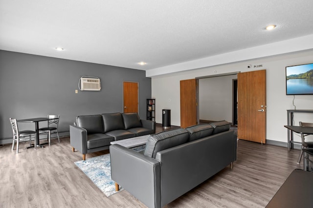 4 Pine Tree Dr Unit 218, Arden Hills, MN 55112 - living room with a wall unit AC, wood finished floors, recessed lighting, and a baseboard radiator