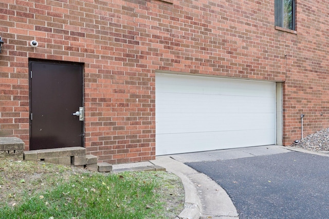4 Pine Tree Dr Unit 218, Arden Hills, MN 55112 - view of exterior entry with brick siding and a surveillance system