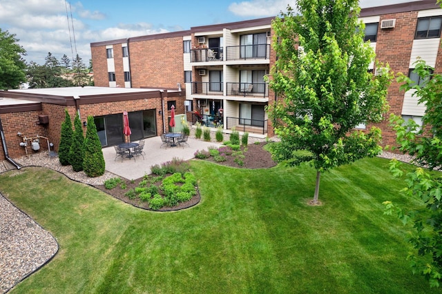 4 Pine Tree Dr Unit 218, Arden Hills, MN 55112 - rear view of property with brick siding, a patio, and a lawn