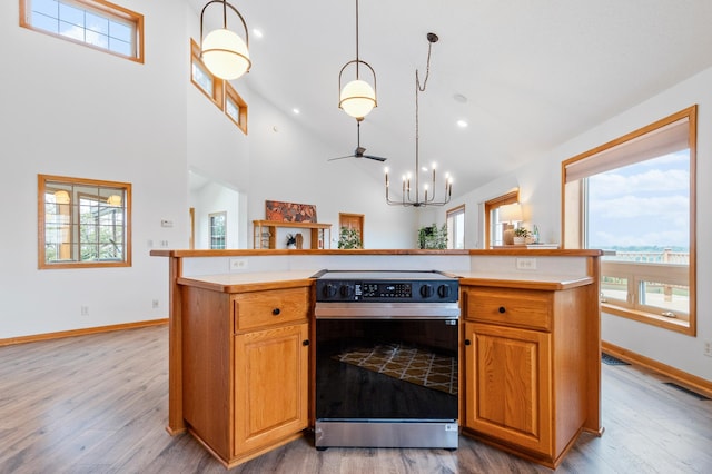 360 Karens Way NW, Alexandria, MN 56308 - kitchen featuring black range with electric cooktop, wood finished floors, light countertops, high vaulted ceiling, and recessed lighting