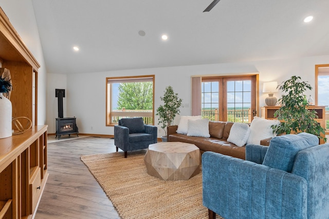 360 Karens Way NW, Alexandria, MN 56308 - living area featuring a wood stove, healthy amount of natural light, vaulted ceiling, light wood finished floors, and recessed lighting