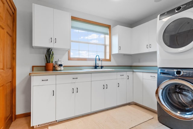 360 Karens Way NW, Alexandria, MN 56308 - laundry area with stacked washer / dryer, cabinet space, and light tile patterned floors