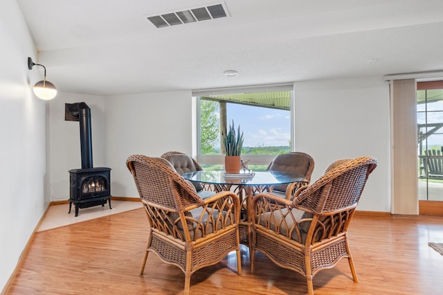 360 Karens Way NW, Alexandria, MN 56308 - dining area featuring light wood-style flooring and a wood stove