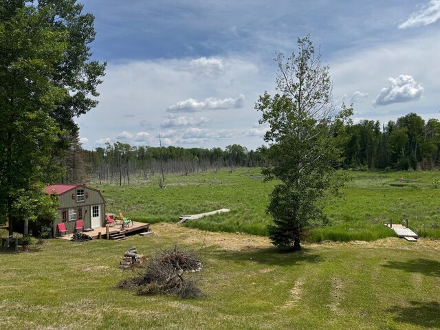 41251 Turtle Lake Rd, Stokes Twp, MN 56628 - view of yard featuring a wooden deck and an outdoor fire pit