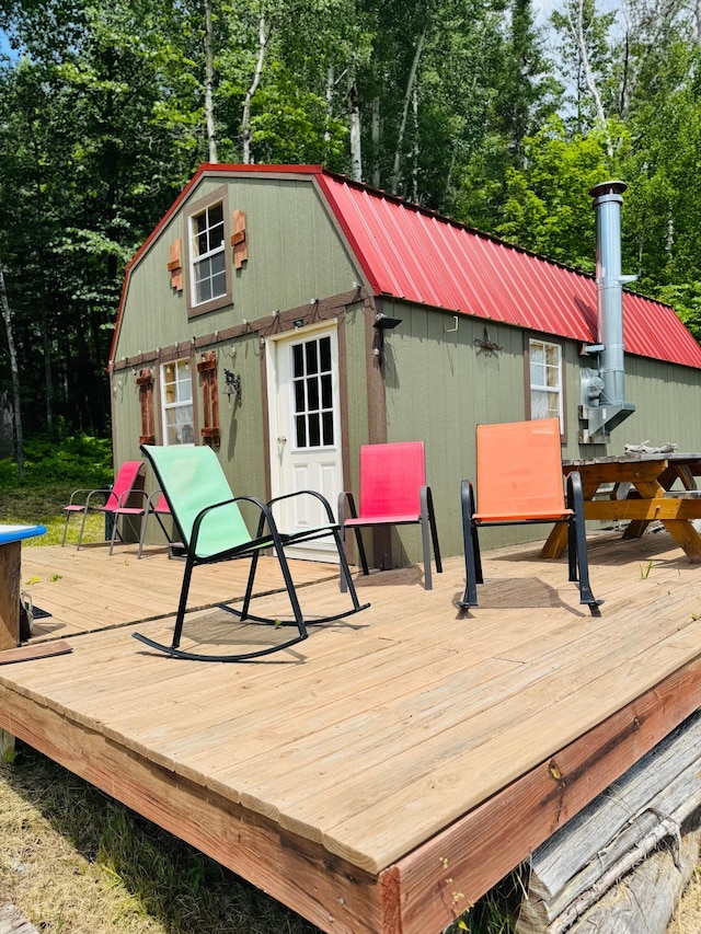 41251 Turtle Lake Rd, Stokes Twp, MN 56628 - wooden terrace featuring view of wooded area and an outdoor structure