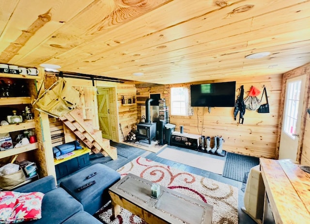 41251 Turtle Lake Rd, Stokes Twp, MN 56628 - living area featuring wooden walls, a wood stove, a barn door, wooden ceiling, and wood finished floors