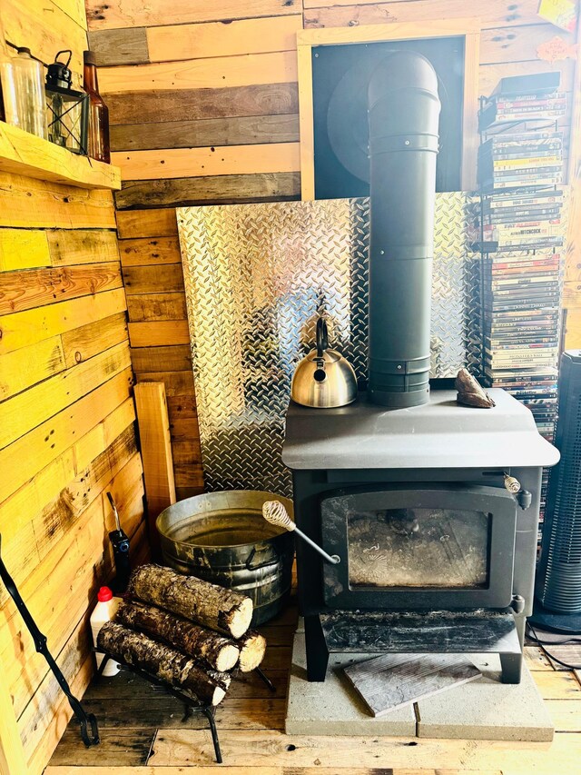41251 Turtle Lake Rd, Stokes Twp, MN 56628 - detailed view of a wood stove, wood walls, and wood finished floors