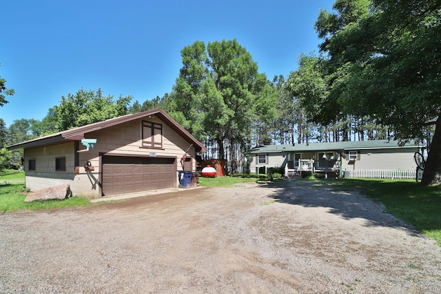 30348 422nd Ln, Aitkin, MN 56431 - view of front of home featuring concrete block siding, an outdoor structure, and a garage