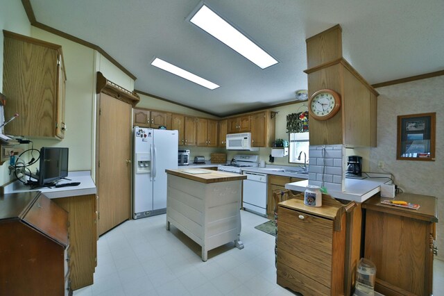 30348 422nd Ln, Aitkin, MN 56431 - kitchen featuring white appliances, lofted ceiling, light countertops, ornamental molding, and brown cabinetry