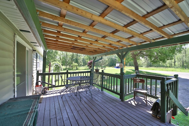 30348 422nd Ln, Aitkin, MN 56431 - deck featuring outdoor dining space, a lawn, and view of wooded area
